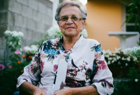 Elderly woman dressed nicely and sitting down